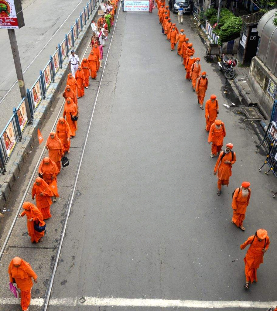Acaryas walking along a city road